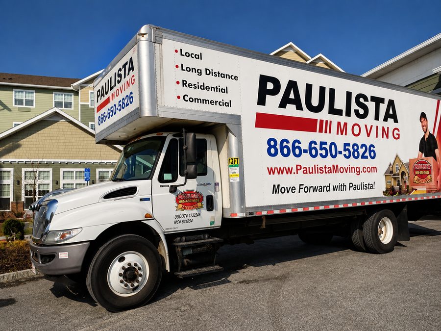Paulista Moving truck parked outside a commercial building complex in Middlesex County