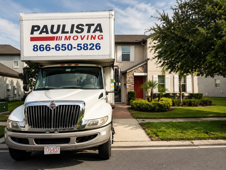 Paulista Moving commercial truck parked in front of a residential home in Massachusetts